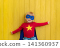 Little boy dressed as a superhero having fun at home 141360937