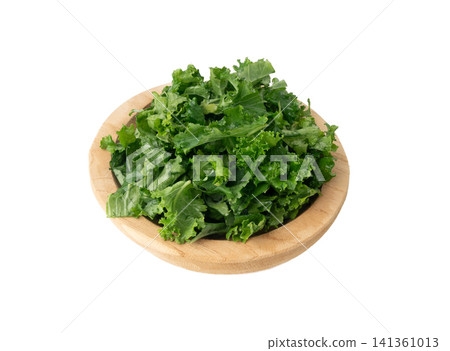 Pieces of kale cabbage leaves isolated. Green leaf of curly cabbage cooked for fresh salad Pieces of kale cabbage leaves isolated. Green leaf of curly cabbage cooked for fresh salad 141361013
