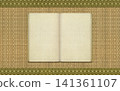 An old Japanese-style bound book and a background of rush grass tatami mats with borders. 141361107