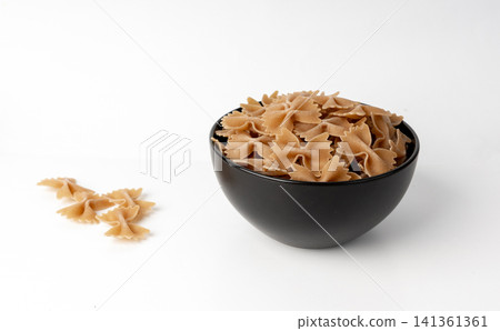 Raw Brown Farfalle Pasta Isolated Raw Brown Farfalle Pasta Isolated 141361361