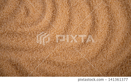 Brown cane sugar pile textured background top view Brown cane sugar pile textured background top view 141361377
