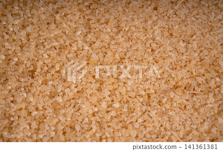 Brown cane sugar pile textured background top view Brown cane sugar pile textured background top view 141361381
