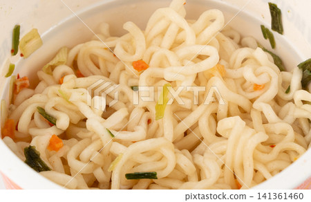 Dry instant noodles in cup isolated. Raw spaghetti in a plastic cup, fast food pasta in container 141361460