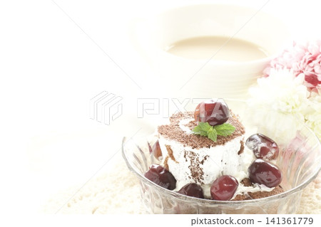 Roll cake topped with frozen grapes and milk tea Roll cake topped with frozen grapes and milk tea 141361779