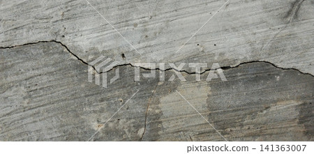 A close-up photo showing a concrete surface with a rough texture and a weathered appearance. 141363007