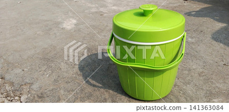 High-angle photo showing a bright lime green insulated plastic thermos. High-angle photo showing a bright lime green insulated plastic thermos. 141363084