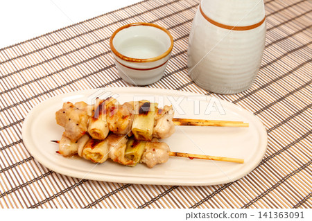 Grilled chicken skewers (chicken and green onion) seasoned with salt, and sake. Grilled chicken skewers (chicken and green onion) seasoned with salt, and sake. 141363091