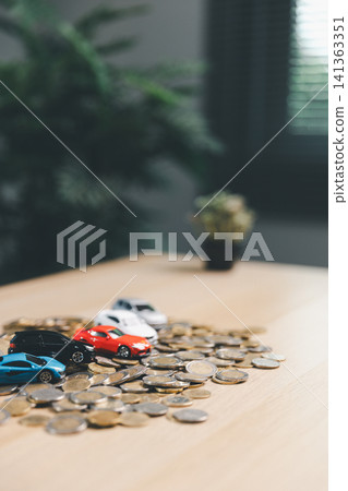 Multiple miniature cars on scattered coins, illustrating auto market cost, car financing, vehicle purchase budget, insurance payment, and transportation expense concept. Multiple miniature cars on scattered coins, illustrating auto market cost, car financing, vehicle purchase budget, insurance payment, and transportation expense concept. 141363351
