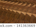This is a patterned wooden cutting board. 141363669