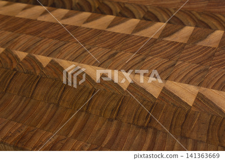 This is a patterned wooden cutting board. 141363669