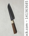 It is a kitchen knife placed against a white background. 141363685