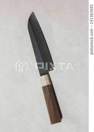 It is a kitchen knife placed against a white background. It is a kitchen knife placed against a white background. 141363685