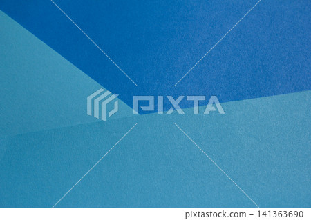 It is a blue colored paper background. It is a blue colored paper background. 141363690