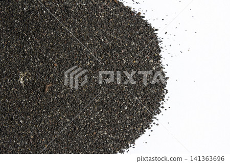 It is black sand scattered on a white background. 141363696