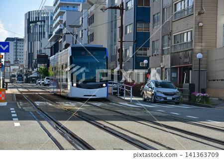 Streetcars and urban transport running through city areas Streetcars and urban transport running through city areas 141363709