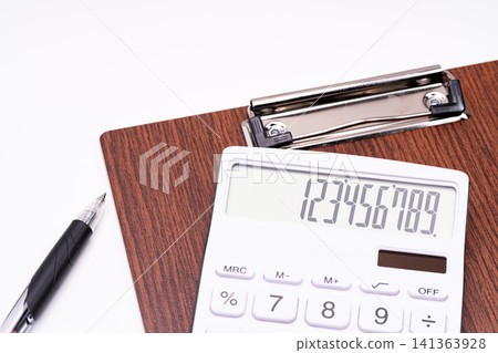 A composition featuring a calculator and office supplies, highlighting the brown texture. A composition featuring a calculator and office supplies, highlighting the brown texture. 141363928