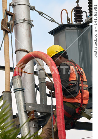 A high-voltage electrician on site A high-voltage electrician on site 141363981