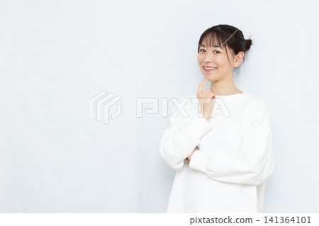 A woman who is worried about her smile A woman who is worried about her smile 141364101