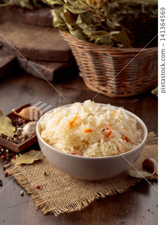 Homemade sauerkraut with carrot on an old wooden table. Homemade sauerkraut with carrot on an old wooden table. 141364569