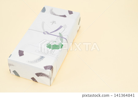 A return gift wrapped in a special paper for funerals. A return gift wrapped in a special paper for funerals. 141364841