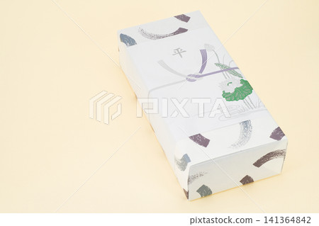 A return gift wrapped in a special paper for funerals. A return gift wrapped in a special paper for funerals. 141364842