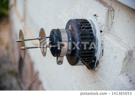 The exhaust pipe of a gas boiler of an autonomous heating system sticks out of the wall. The exhaust pipe of a gas boiler of an autonomous heating system sticks out of the wall. 141365053