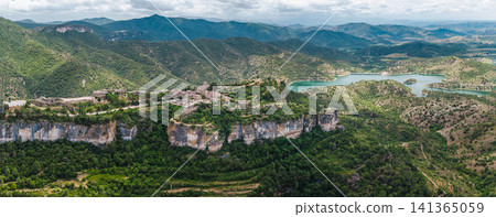 Aerial view of Siurana village perched on dramatic sandstone cliffs above Siurana Reservoir in Catalonia, Spain Aerial view of Siurana village perched on dramatic sandstone cliffs above Siurana Reservoir in Catalonia, Spain 141365059