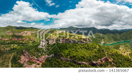 Panoramic aerial view of Siurana perched on towering cliffs above a winding reservoir in Catalonia, Spain. Panoramic aerial view of Siurana perched on towering cliffs above a winding reservoir in Catalonia, Spain. 141365067