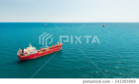 Red tanker ship anchored in turquoise sea viewed from aerial drone Red tanker ship anchored in turquoise sea viewed from aerial drone 141365068