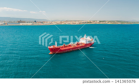 Red tanker ship anchored near coastal city and commercial port viewed from aerial drone Red tanker ship anchored near coastal city and commercial port viewed from aerial drone 141365076