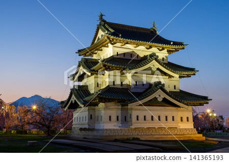 Hirosaki Park, Shimoshirogane-cho, Hirosaki City, Aomori Prefecture: Hirosaki Castle keep illuminated and the sunset over Mt. Iwaki, surrounded by cherry blossoms including weeping cherry trees. Hirosaki Park, Shimoshirogane-cho, Hirosaki City, Aomori Prefecture: Hirosaki Castle keep illuminated and the sunset over Mt. Iwaki, surrounded by cherry blossoms including weeping cherry trees. 141365193