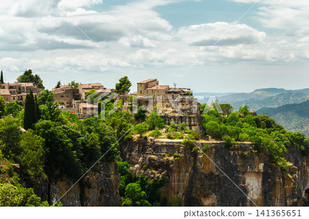 Siurana medieval village overlooking dramatic canyon cliffs and forested mountains, panoramic landscape of one of Catalonia Siurana medieval village overlooking dramatic canyon cliffs and forested mountains, panoramic landscape of one of Catalonia 141365651