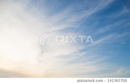 A serene and expansive sky featuring soft, wispy cirrus clouds  141365708