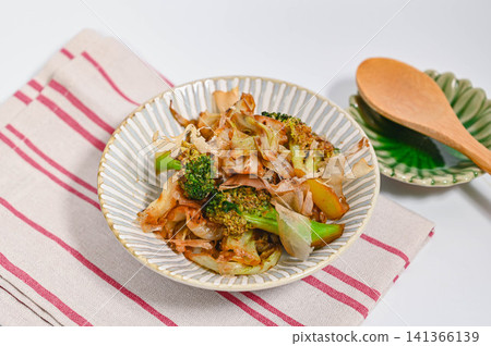 Stir-fried broccoli and cabbage with soy sauce, topped with bonito flakes. Stir-fried broccoli and cabbage with soy sauce, topped with bonito flakes. 141366139