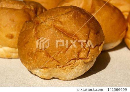 It is a well-baked morning roll. It is a well-baked morning roll. 141366699