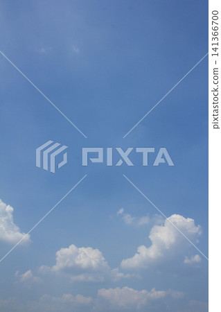 It is a blue sky with fluffy clouds. It is a blue sky with fluffy clouds. 141366700