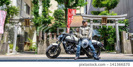 A male motorcyclist taking a break at Sanuki Kobai Inari Shrine 141366870