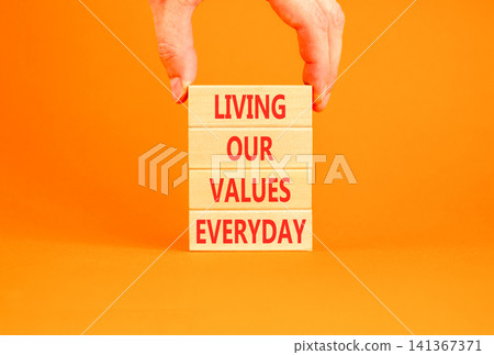 Living our values everyday words symbol. Concept words Living our values everyday on beautiful wooden blocks. Beautiful orange background. Business living our values everyday concept. Copy space. Living our values everyday words symbol. Concept words Living our values everyday on beautiful wooden blocks. Beautiful orange background. Business living our values everyday concept. Copy space. 141367371