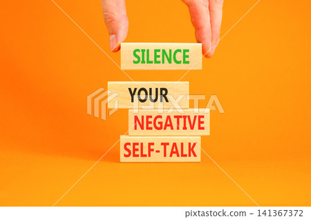 Silence your negative self-talk symbol. Concept words Silence your negative self-talk on beautiful wooden blocks. Beautiful orange background. Psychological negative self-talk concept. Copy space. Silence your negative self-talk symbol. Concept words Silence your negative self-talk on beautiful wooden blocks. Beautiful orange background. Psychological negative self-talk concept. Copy space. 141367372