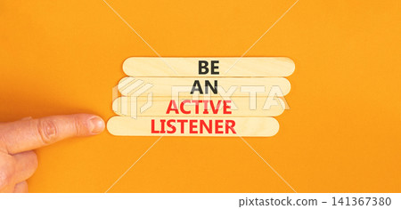 Be an active listener words symbol. Concept words Be an active listener on beautiful wooden sticks. Beautiful orange background. Businessman hand. Business be an active listener concept. Copy space. Be an active listener words symbol. Concept words Be an active listener on beautiful wooden sticks. Beautiful orange background. Businessman hand. Business be an active listener concept. Copy space. 141367380