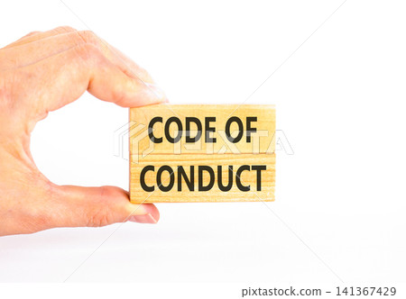 Code of conduct words symbol. Concept words Code of conduct on beautiful wooden blocks. Beautiful white background. Businessman hand. Business Code of conduct concept. Copy space. Code of conduct words symbol. Concept words Code of conduct on beautiful wooden blocks. Beautiful white background. Businessman hand. Business Code of conduct concept. Copy space. 141367429