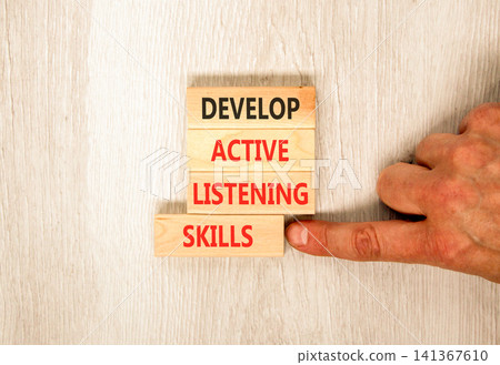 Develop active listening skills symbol. Concept words Develop active listening skills on beautiful wooden blocks. Beautiful grey wooden background. Business active listening skills concept. Copy space Develop active listening skills symbol. Concept words Develop active listening skills on beautiful wooden blocks. Beautiful grey wooden background. Business active listening skills concept. Copy space 141367610
