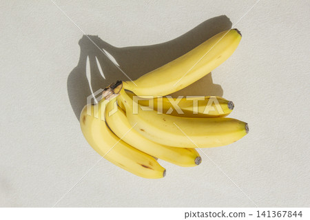 It is a banana placed on a white background. It is a banana placed on a white background. 141367844