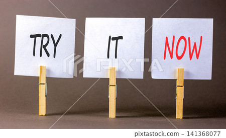 Try it now words symbol. Concept words Try is now on beautiful white papers on wooden clothespin. Beautiful grey background. Business support motivational and try is now concept. Copy space. Try it now words symbol. Concept words Try is now on beautiful white papers on wooden clothespin. Beautiful grey background. Business support motivational and try is now concept. Copy space. 141368077
