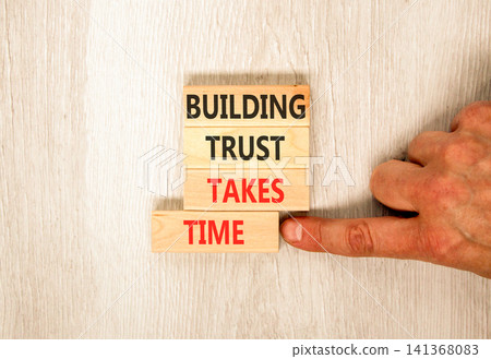 Building trust takes time words symbol. Concept words Building trust takes time on beautiful wooden blocks. Beautiful grey wooden background. Business building trust takes time concept. Copy space. 141368083