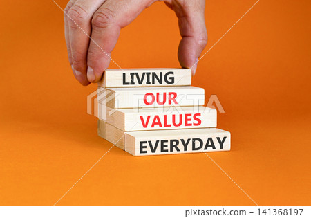 Living our values everyday words symbol. Concept words Living our values everyday on beautiful wooden blocks. Beautiful orange background. Business living our values everyday concept. Copy space. 141368197