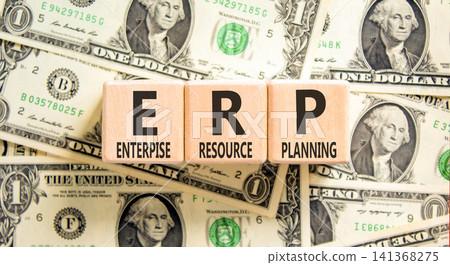 ERP enterprise resource planning symbol. Concept words ERP enterprise resource planning on beautiful wooden blocks. Beautiful dollar bills background. Business ERP concept. Copy space. ERP enterprise resource planning symbol. Concept words ERP enterprise resource planning on beautiful wooden blocks. Beautiful dollar bills background. Business ERP concept. Copy space. 141368275