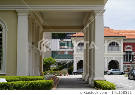 Architectural Walkway with Green Hedges and Classic Buildings Architectural Walkway with Green Hedges and Classic Buildings 141368551