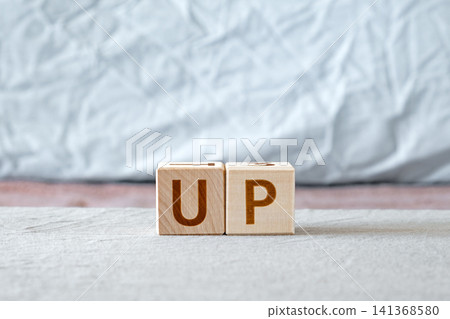 motivational word Up made of letters on wooden cubes motivational word Up made of letters on wooden cubes 141368580