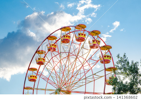 ferris wheel attraction with cabins against the sky ferris wheel attraction with cabins against the sky 141368602